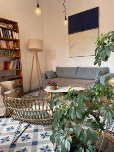 a living room with a couch and a table at un oasis au coeur de la vieille ville, classé 4 étoiles in Montpellier