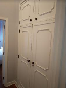 
a white door is open in a room at Hotel Jardim Viana do Castelo in Viana do Castelo
