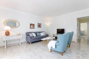 a living room with a couch and a table at YourHouse Germanor, quiet beach house in Majorca North in Son Serra de Marina