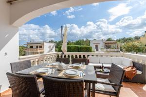 a patio with a table and chairs on a balcony at YourHouse Germanor, quiet beach house in Majorca North in Son Serra de Marina