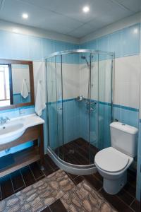 a bathroom with a shower and a toilet and a sink at Selena Hotel in Balchik