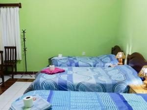 a bedroom with a bed and a table with two beds at Tierra Nuestra in Tarija