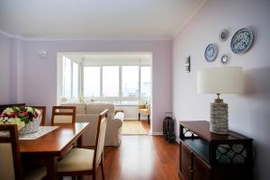 a living room with a table and a dining room at VistaoMar in São João do Estoril +18 photos