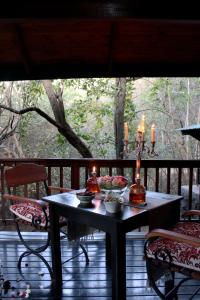 a table on a porch with candles on it at Thulamela Couples Retreat in Hazyview