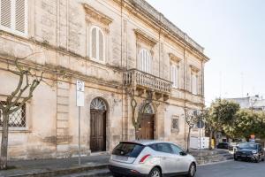 a silver car parked in front of a building at Palazzo Rapanà - Luxury Apt with hydromassage pool in Ostuni
