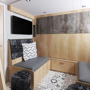 a small room with a seat and a tv in it at The Willy Gunn Pod - Beautiful, luxury pod in Aberlour