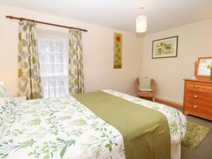 Ένα ή περισσότερα κρεβάτια σε δωμάτιο στο Badger Cottage