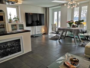 a living room with a table and a fireplace at Ambiente in Radolfzell am Bodensee