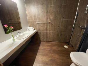 a bathroom with a shower and a sink and a toilet at Sømna Kro & Gjestegård in Vik +53 photos
