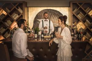 eine Braut und ein Bräutigam stehen an einer Bar in der Unterkunft Monte Mulini Adults Exclusive Hotel by Maistra Collection in Rovinj