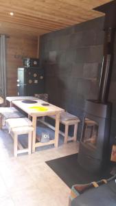 a living room with a wood stove and a table at Le Chalet de Lili in Névache