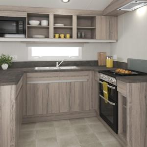 a kitchen with wooden cabinets and a stove top oven at The Salmon Van - Beautiful, luxury static caravan in Aberlour