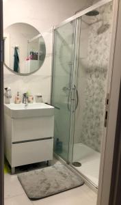 a bathroom with a glass shower and a sink at M & A Apartment Bar A 29 in Bar