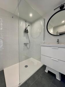 a bathroom with a shower and a sink and a mirror at Le gîte de l’espérance in Arc-en-Barrois
