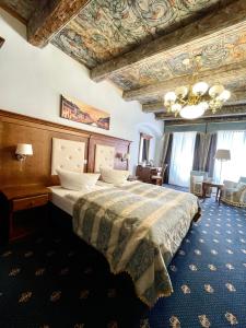 格爾利茨的住宿－Hotel Italia，一间卧室设有一张带格子天花板的大床