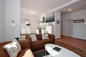 a living room with a couch and a table at Macoma Baltica Wohnung 04 in Kühlungsborn