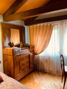 a bedroom with a wooden dresser and a window at Attico con Altana in Venice
