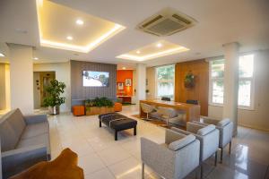a large living room with couches and a tv at Zago Hotel in Lages