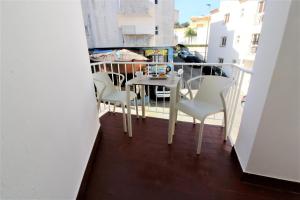 a balcony with a table and chairs on it at Historic Centre C - Albufeira in Albufeira