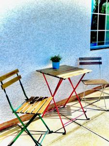 a table and two chairs and a table and a plant at Anchor Inn in Taunton