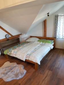 a bedroom with a bed in a attic at Apartmán Červenka in Hartmanice
