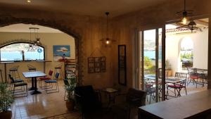 a room with a table and chairs and a balcony at Boutique Villa Revelin in Pag +37 photos