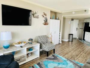 a living room with a tv on a wall at 1602 Coastal Soul Pet friendly in Myrtle Beach