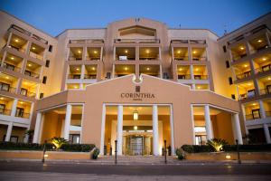 a building with a sign on the front of it at Corinthia St George's Bay in St. Julianʼs