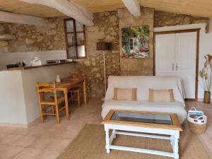 a living room with a couch and a table at Gîte Les Fourches in Baudinard