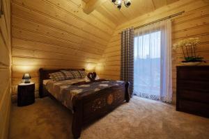 a bedroom with a bed and a window in a room at Domek Dream Holiday in Poronin +65 photos