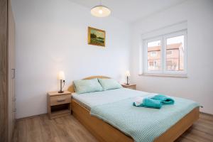 Postel nebo postele na pokoji v ubytování Apartments Jakoplić
