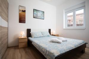 Postel nebo postele na pokoji v ubytování Apartments Jakoplić