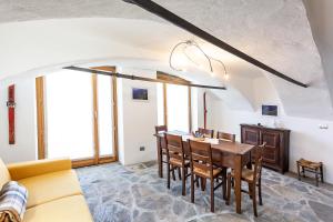 a kitchen and dining room with a table and chairs at Agriturismo Valliera in Castelmagno