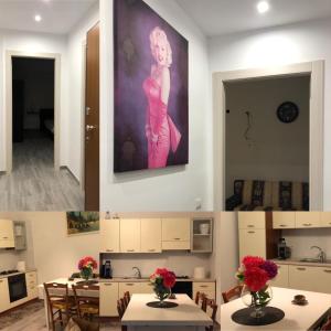 una habitación con mesas y una pintura de una mujer en la pared en B&B SKY LINE en Crotone