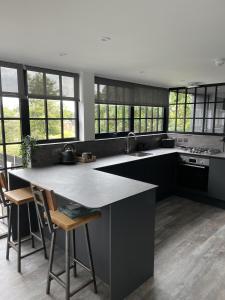 a kitchen with a large island in the middle at Booking Urban at Halstead in Halstead