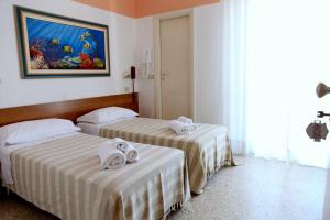 Rúm í herbergi á Hotel Staccoli