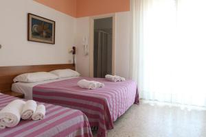 Rúm í herbergi á Hotel Staccoli