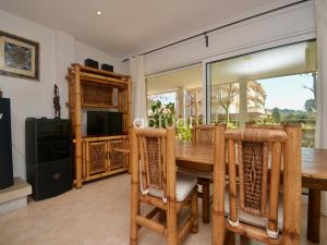 a dining room with a wooden table and chairs at Gavina Esc B Bajos B in Sant Feliu de Guixols
