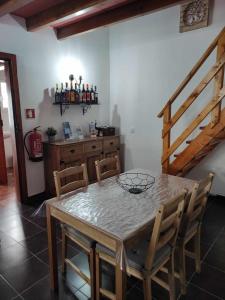 a dining room with a table and chairs and a staircase at Di&Ana II - Alojamento Redondo in Redondo