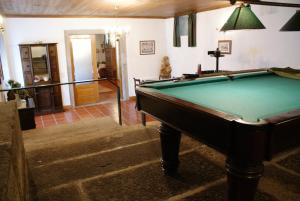a living room with a pool table in it at Quinta de São Bento in Vila de Prado