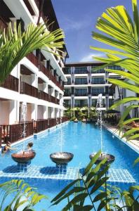 a swimming pool with fountains in the middle of a building at Apasari Krabi - SHA Extra Plus in Ao Nang Beach