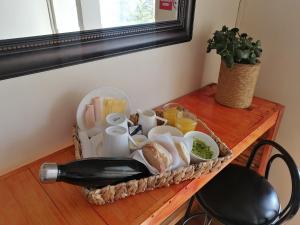 a basket of food and a bottle of wine on a table at Hotel 251 in Viña del Mar