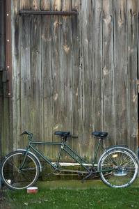 a bike parked in front of a wooden fence at Agroturystyka - Wypoczynek nad stawem na Kaszubach in Karsin