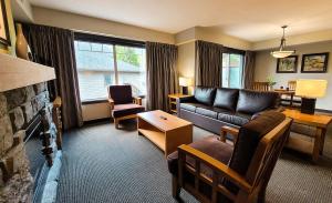 a living room with a couch and a fireplace at Copperstone Resort in Dead Man's Flats