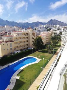 a view from the balcony of a building with a swimming pool at Appartment Beach Golf in Benalmádena