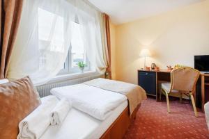 Voodi või voodid majutusasutuse Hotel Tábor toas
