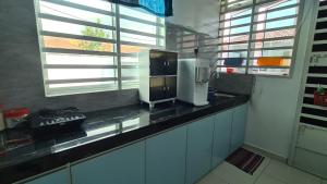 a kitchen with a counter with a coffee maker on it at Rest n Splash by Home Stay Cikgu D'Inapan Kijang in Alor Setar
