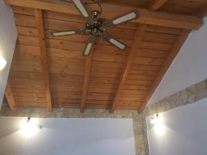 a ceiling fan hanging from a wooden ceiling at Apartments More - sea front in Savar