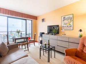 a living room with a couch and a tv at Apartment Les Hauts de Bordagain-3 by Interhome in Ciboure