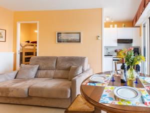 a living room with a couch and a table at Apartment Les Hauts de Bordagain-3 by Interhome in Ciboure